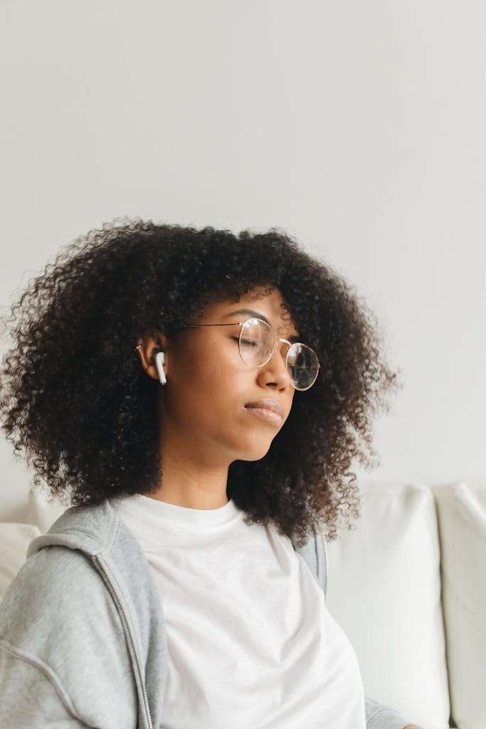 Woman in Gray Sweater Listening to Music